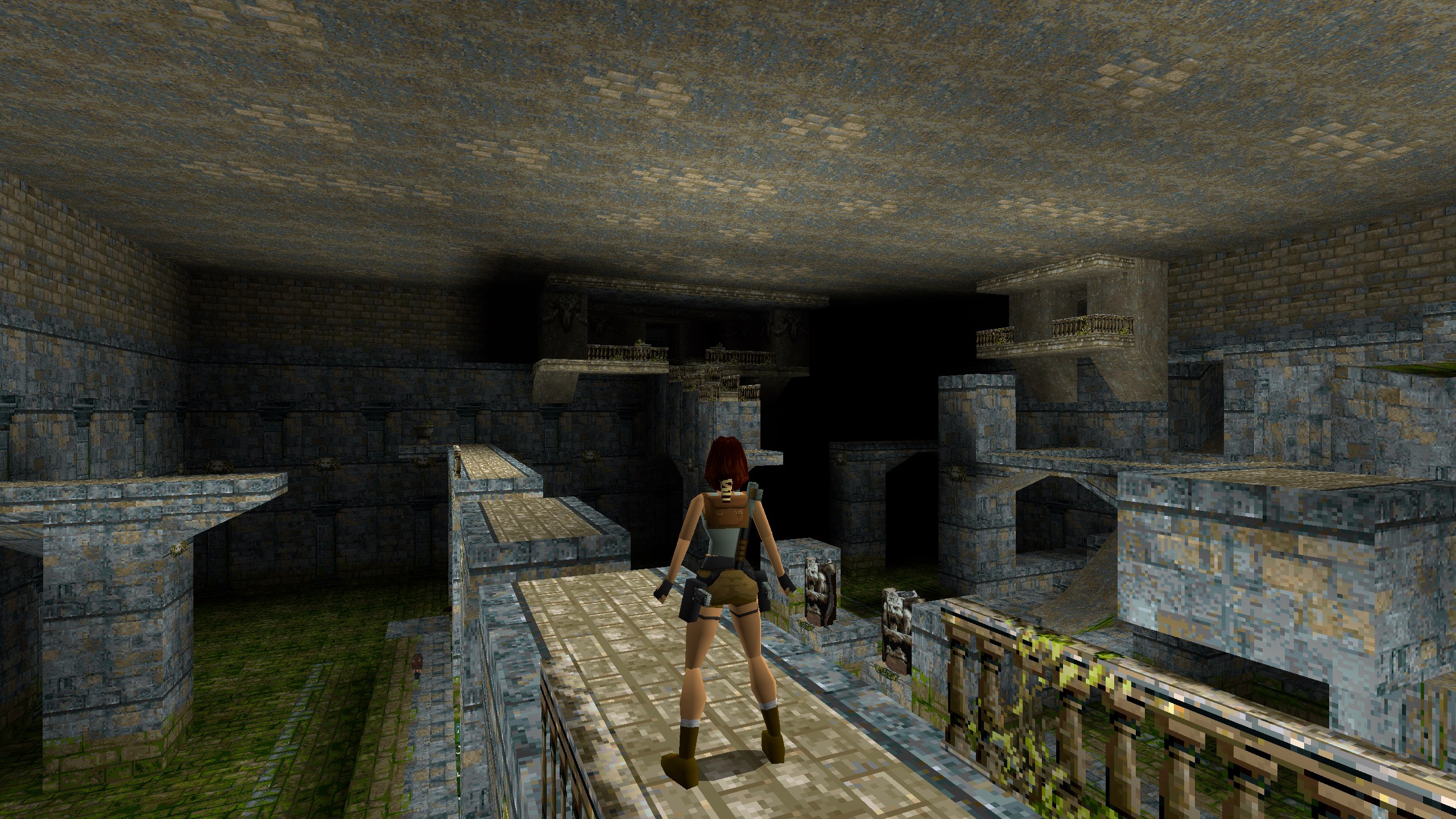 Lara looks around a large cistern from a high ledge