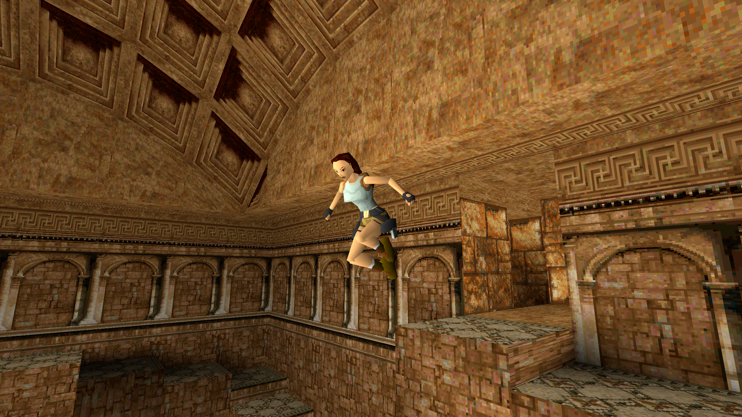 Lara leaps through the air in a large stone room