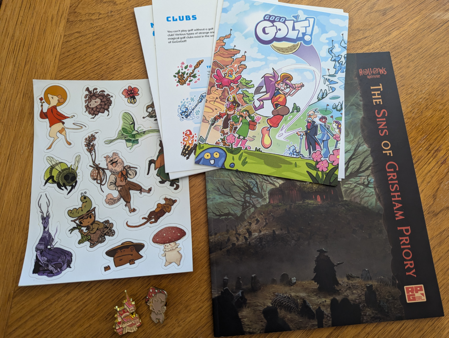 Games, stickers, and enamel pins spread on the table